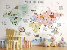 a child's room with a map of the world on the wall and toys