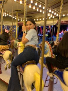 a woman sitting on top of a merry go round