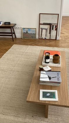 a coffee table with books and magazines on it