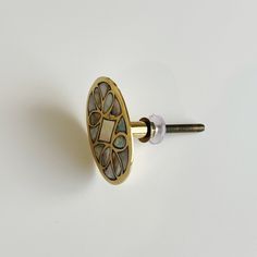 an antique brass door knob with glass inserts on the front and back sides, set against a plain white background