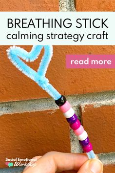 a hand holding a toothbrush in front of a brick wall with the words breathing stick calming strategy craft