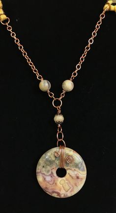 Crazy Lace Agate and Copper Necklace with soft jersey cord. 38" long Main Focal is 2" long Coated with Protectaclear ProtectaClear is a clear, protective coating that is tough enough to protect jewelry and is safe for wear against skin. ProtectaClear is practically invisible once applied and will seal and protect jewelry from tarnish, oxidation, and corrosion Donut Jewelry Pendants, Adjustable Long Agate Crystal Necklace, Leather Bracelet Tutorial, Donut Jewelry, Beaded Ideas, Wire Wrapped Stone Jewelry, Donut Pendant, Wire Jewelry Tutorial, Beading Patterns Free