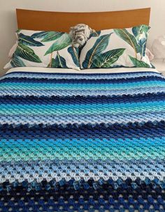 a crocheted blanket is on top of a bed