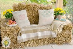 a couch made out of hay with pillows on it