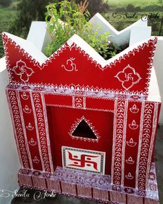 a red and white box with designs on it