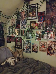 a bedroom with posters and stuffed animals on the wall