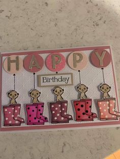 a happy birthday card with pink boots and polka dots