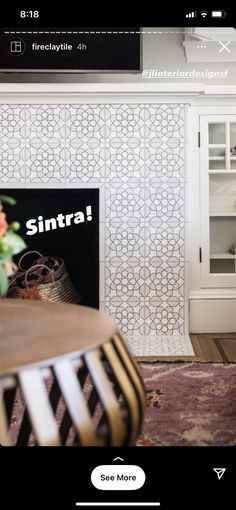 a living room with an entertainment center and white wallpaper on the walls that says sintra