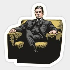 a man in a suit and tie sitting on a chair