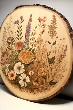 a wood slice with a bunch of wildflowers wood burned on it and painted in with pencil crayon and watercolor paint. Unique Woodburning Ideas, Earthy Paintings Canvas, Wood Burn And Paint, Wood Pyrography Ideas, Fall Woodburning Ideas, Wood Burning Inspiration, Wood Burn Trees, Wedding Wood Burning Ideas, Burned Wood Art