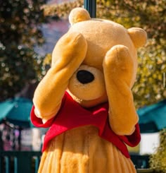 a large teddy bear dressed in a yellow dress