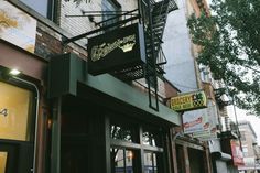 the outside of a restaurant with stairs leading up to it's doors and windows