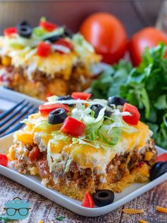 mexican casserole on a plate topped with lettuce and black olives