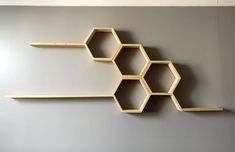 the shelves are made out of wood and have hexagons attached to them