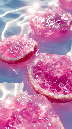 three pieces of grapefruit floating on top of water