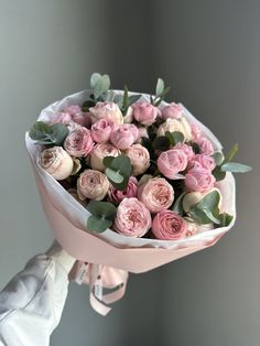 a person holding a bouquet of flowers in their hand