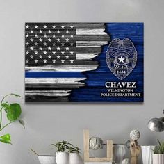 an american flag and police badge painted on a wall above a table with other items