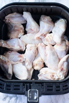 raw chicken in an air fryer basket ready to be cooked