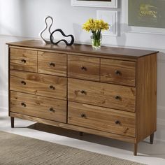 a wooden dresser with yellow flowers on top