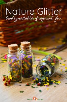 three bottles filled with confetti and sprinkles on top of a wooden table