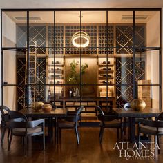 an elegant dining room with glass walls and wooden floors