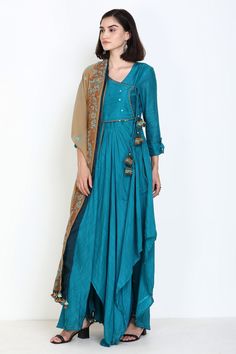 Turquoise angarakha kurta with mirror work and asymmetrical hem. Comes with churidar and embroidered dupatta.
Component: 3
Pattern: Embroidery
Type Of Work: Thread and Mirror
Neckline: V neck
Sleeve Type: Three Fourth
Fabric: Slub Muslin
Color: Blue
Other Details: 
Dupatta with embroidery and tassel detail
Button tabs on the sleeves
Tie up on the side
Occasion: Wedding - Aza Fashions Anarkali Long Sleeve Pre-draped Saree For Diwali, Traditional Pre-draped Saree With Sheer Dupatta And Long Sleeves, Diwali Anarkali Long Sleeve Pre-draped Saree, Designer Long Sleeve Pre-draped Saree For Eid, Festivals Anarkali Style Pre-draped Saree With Long Sleeves, Long Sleeve Pre-draped Saree With Cutdana, Fitted Anarkali Handloom Kurta, Long Sleeve Pre-draped Saree For Navratri, Designer Front Open Kurta With Dupatta