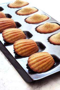 a muffin tin filled with cookies sitting on top of a counter