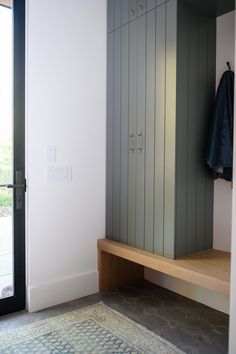 a room with a large cabinet and a rug on the floor