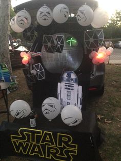 a star wars themed vehicle with balloons and lights in the shape of darth vader's helmet