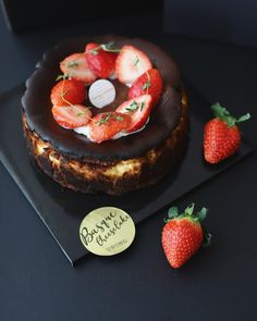 there is a chocolate cake with strawberries on it