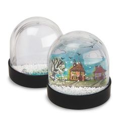 two snow globes sitting next to each other