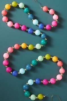 a multicolored beaded necklace on a blue background