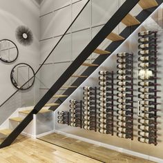 there is a wine rack on the wall next to the stairs in this room,