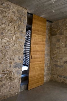 an empty room with stone walls and wooden doors