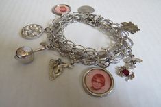 Interesting unique sterling silver charm bracelet with 8 fine charms Bracelet measures 7 in long and 1/2 in wide 2 Aquarius charms 1 Love Bug 1 Calypso 1 Pearl Tree 2 children's pix 1 maple leaf What a wonderful gift for the sentimental collector.  Good condition. The price is $125.00 Canadian funds total. We ship via Canada Post with inclusion of insurance against loss. You will receive a tracking number. We package with care and ship promptly. Sterling Silver Bracelets With Vintage Charm For Gift, Sterling Silver Keepsake Bracelets In Silver, Sterling Silver Keepsake Bracelet, Sterling Silver Bracelets With Vintage Charm As A Gift, Nickel-free Silver Charm Bracelet Collectible, Personalized Sterling Silver Charms For Collectors, Silver Round Charms For Personalized Gifts, Nickel-free Silver Charm Bracelet For Collectors, Silver Charm Bracelet With Lobster Clasp For Personalized Gift