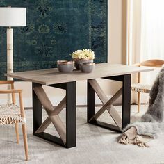 a wooden table with two bowls on it in front of a green rug and chair