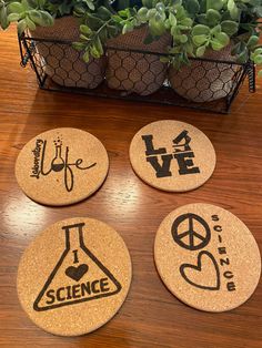 four cork coasters with the words science and i love life written on them in different languages