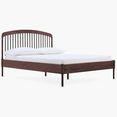 the bed frame is made from wood and has white sheets on it, while the headboard