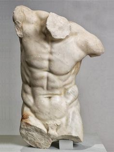 a white marble sculpture of a man with his back turned to the side and muscles exposed