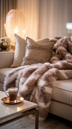 a living room with a couch, coffee table and fur throw blanket on top of it