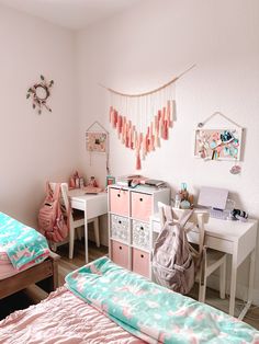 a bedroom with two beds, desks and other items on the wall in it