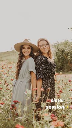 two girls standing in the middle of a field full of flowers wearing hats and dresses