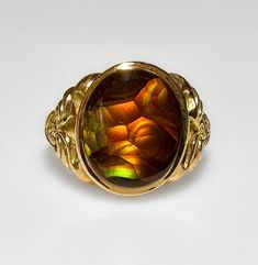 Vintage Retro c1970s This is one of my favorites and good fire agates are not the easiest to find. From the detailed gold work on the band featuring a vibrant 2.4 ct Fire Agate. Likely a gents pinky ring. Today, men or women could wear this easily. An absolute beauty. 5g 14k solid yellow gold Hallmarked Fire Agate 2.4 ct Face measures 14mm S 4 US Antique Gold Opal Ring Collectible, Collectible Gold Opal Gemstone Ring, Collectible Gold Opal Ring With Gemstone, Collectible Yellow Gold Opal Ring Oval Cabochon, Vintage Gold Opal Ring With Polished Finish, Collectible Oval Cabochon Opal Ring In Yellow Gold, Vintage Gold Opal Cabochon Ring, Vintage Oval Cabochon Opal Ring Collectible, Vintage Collectible Opal Ring With Oval Cabochon