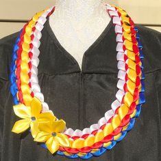 a graduation gown is adorned with colorful ribbons