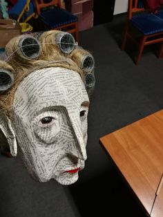 a paper mache head with lots of hair on it's head and eyes