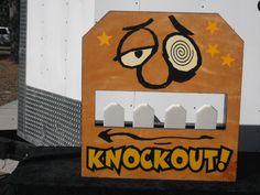 a sign that says knockout on the side of a white and brown truck with yellow stars