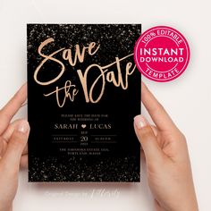 two hands holding up a black and gold save the date card with glitter on it