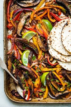 mexican food with tortillas and peppers on a baking sheet, ready to be eaten