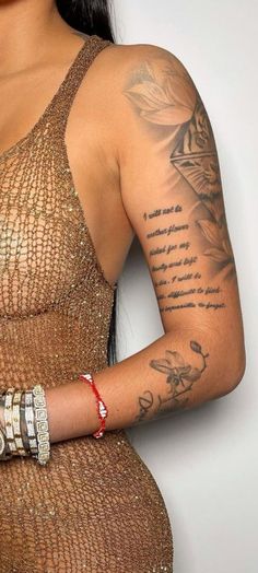 a woman with tattoos on her arm holding a cell phone