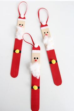 three santa claus pencils made out of paper